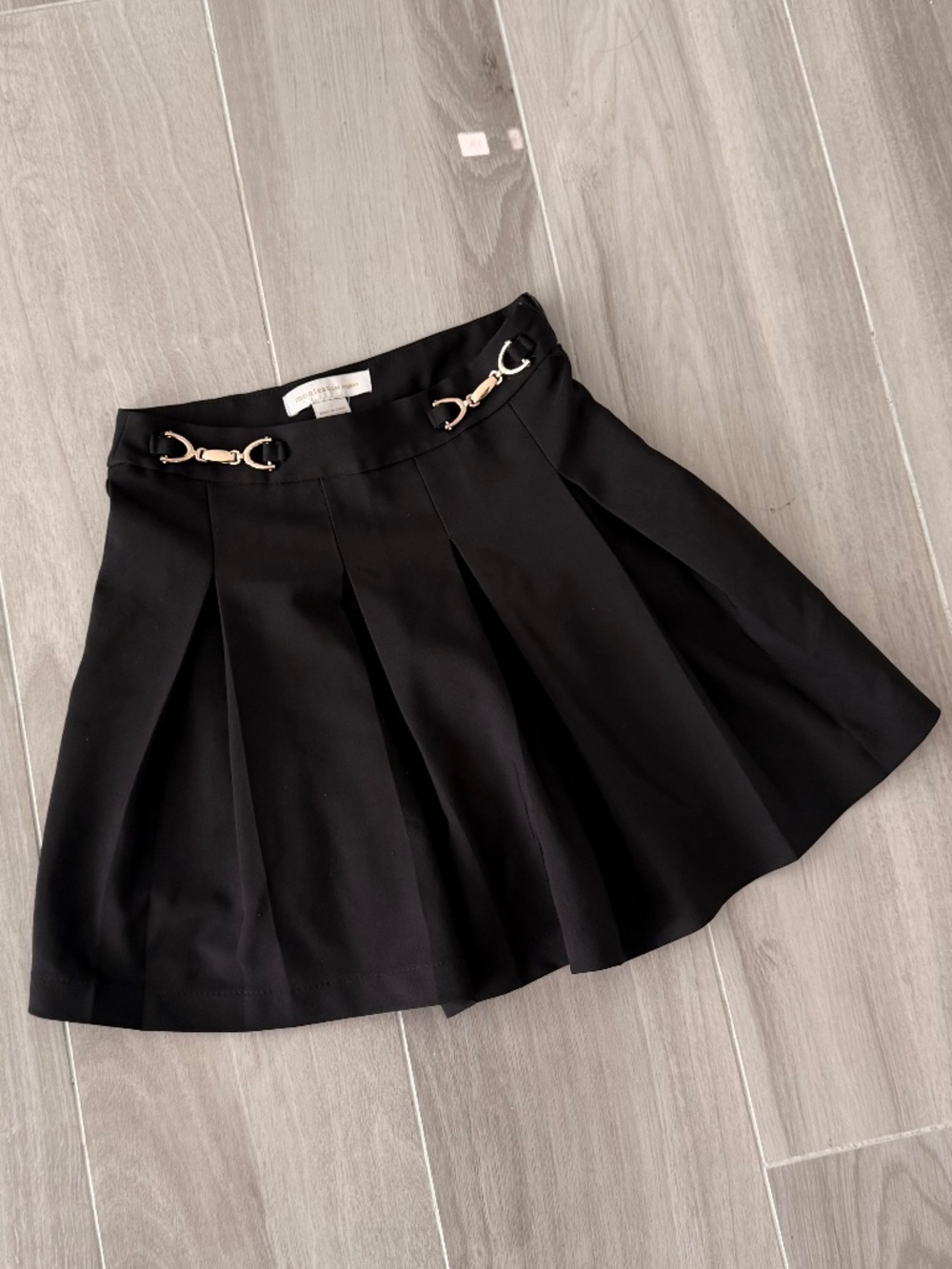Black pleated skirt with gold details